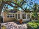 Charming exterior view of home featuring brick patio, inviting entrance, and beautiful landscaping at 1122 Vassar St, Orlando, FL 32804