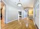 Bright foyer showcasing beautiful hardwood floors and a view of the bedrooms through doorways at 1122 Vassar St, Orlando, FL 32804
