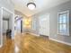 Inviting foyer featuring hardwood floors, neutral paint, and a modern lighting fixture at 1122 Vassar St, Orlando, FL 32804