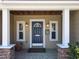 Welcoming front entrance featuring a classic blue door, stone accents, and stylish lighting fixtures at 1122 Vassar St, Orlando, FL 32804