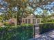 Beautiful single-story home featuring mature landscaping and a black metal fence at 1122 Vassar St, Orlando, FL 32804