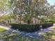 Lovely home with a manicured front yard, mature trees, and an elegant black fence at 1122 Vassar St, Orlando, FL 32804