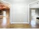 Open hallway with two bedroom views, hardwood floors, and neutral wall colors at 1122 Vassar St, Orlando, FL 32804