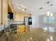 Modern kitchen with stainless steel appliances, granite counters, and bright, natural-stained wood cabinetry at 1122 Vassar St, Orlando, FL 32804