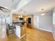 Stylish kitchen with breakfast bar, stainless steel appliances, and adjacent living space at 1122 Vassar St, Orlando, FL 32804