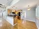 Open kitchen with stainless appliances, light wood cabinets, and hardwood floors at 1122 Vassar St, Orlando, FL 32804