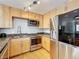 Modern kitchen features stainless steel appliances and light wood cabinetry at 1122 Vassar St, Orlando, FL 32804