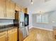 Spacious kitchen with stainless appliances, granite counters, natural wood cabinets, and a breakfast area at 1122 Vassar St, Orlando, FL 32804