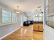 Bright, open living area featuring hardwood floors, modern lighting, and view into Gathering room at 1122 Vassar St, Orlando, FL 32804