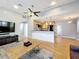 Open-concept living space with kitchen, modern furnishings, and hardwood floors at 1122 Vassar St, Orlando, FL 32804