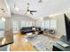 Inviting living space with a ceiling fan, hardwood floors, and large windows for ample natural light at 1122 Vassar St, Orlando, FL 32804