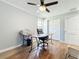 Bright office space with wood floors, a ceiling fan and a window, featuring a work desk at 1122 Vassar St, Orlando, FL 32804