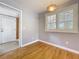 Neutral-toned room with beautiful hardwood floors, decorative lighting, and natural light at 1122 Vassar St, Orlando, FL 32804