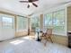 Cozy sunroom with multiple windows, a ceiling fan, and views of the surrounding landscape at 1122 Vassar St, Orlando, FL 32804