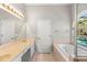Well-appointed bathroom with dual sinks, a jacuzzi tub, and natural light, providing a serene retreat at 1151 Chessington Cir, Lake Mary, FL 32746