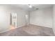 Bright bedroom with carpeting, ceiling fan and two doorways provides access to ensuite bathroom and walk-in closet at 1151 Chessington Cir, Lake Mary, FL 32746