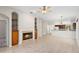 Warm living room with a fireplace, built-in shelves, and a seamless flow into the kitchen at 1151 Chessington Cir, Lake Mary, FL 32746
