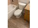 Classic bathroom showing a toilet and tiled bathtub, plus vinyl flooring at 11520 Westwood Blvd # 515, Orlando, FL 32821