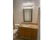 Traditional bathroom featuring a framed mirror, and vanity with granite countertops at 11520 Westwood Blvd # 515, Orlando, FL 32821