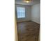Bright bedroom features wood-look flooring and window for natural light at 11520 Westwood Blvd # 515, Orlando, FL 32821