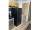 The kitchen features a black refrigerator, range, microwave, and a laundry closet at 11520 Westwood Blvd # 515, Orlando, FL 32821