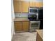 A well-lit kitchen featuring stainless steel appliances, light wood cabinets and countertops at 11520 Westwood Blvd # 515, Orlando, FL 32821