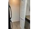 Pantry space with white louvered doors next to the fridge and cabinets at 11520 Westwood Blvd # 515, Orlando, FL 32821