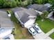 Aerial view of a single story home with screened in enclosure and well manicured lawn at 1567 Oak Hill Trl, Kissimmee, FL 34747
