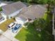 Aerial view of a well-maintained home with a manicured lawn and driveway at 1567 Oak Hill Trl, Kissimmee, FL 34747