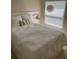 Bright bedroom featuring a comfortable bed with storage, a pineapple themed throw pillow, and a large window at 1567 Oak Hill Trl, Kissimmee, FL 34747