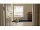 Bedroom with a large window, tiled floors, and a set of drawers at 1567 Oak Hill Trl, Kissimmee, FL 34747