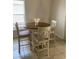 Cozy dining area with a round wooden table, four chairs, and a window for natural light at 1567 Oak Hill Trl, Kissimmee, FL 34747