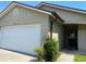 Charming single-story home featuring an attached garage, well-maintained landscaping, and a welcoming front entrance at 1567 Oak Hill Trl, Kissimmee, FL 34747