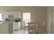 Bright eat-in kitchen with white cabinets and a cozy breakfast nook at 1567 Oak Hill Trl, Kissimmee, FL 34747