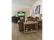 Cozy living room with stylish furnishings, including comfortable seating, tasteful decor, and a large-screen television at 1567 Oak Hill Trl, Kissimmee, FL 34747