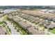 Aerial view of a suburban neighborhood with lake, landscaping, and a school nearby at 16261 Admirals Cove Ln, Winter Garden, FL 34787