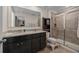 A full bathroom with a double sink vanity, granite countertops, and glass enclosed shower at 16261 Admirals Cove Ln, Winter Garden, FL 34787