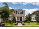 Charming two-story home with neutral paint, dark shutters, and a landscaped yard with a brick walkway at 16261 Admirals Cove Ln, Winter Garden, FL 34787