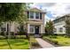Charming two-story home with well-manicured landscaping, brick walkway, and a welcoming front entrance at 16261 Admirals Cove Ln, Winter Garden, FL 34787