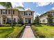 Inviting two-story home with a brick walkway, lush landscaping, and a pleasant facade at 16261 Admirals Cove Ln, Winter Garden, FL 34787