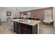 Open concept kitchen featuring a granite island and stainless steel dishwasher and sink with views to living room at 16261 Admirals Cove Ln, Winter Garden, FL 34787