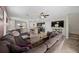 Open-concept living room and kitchen features a large sectional couch, TV, and eat-in kitchen island at 16261 Admirals Cove Ln, Winter Garden, FL 34787