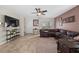 Open-concept living room features a large sectional couch, tile floors, and access to the backyard at 16261 Admirals Cove Ln, Winter Garden, FL 34787