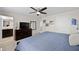 A serene main bedroom featuring a ceiling fan, dresser, and ensuite bathroom at 16261 Admirals Cove Ln, Winter Garden, FL 34787