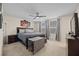 Serene main bedroom with neutral colors, large windows, and a ceiling fan for added comfort at 16261 Admirals Cove Ln, Winter Garden, FL 34787