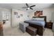 Spacious bedroom featuring a large bed with a cushioned bench, neutral paint, and carpeted floors at 16261 Admirals Cove Ln, Winter Garden, FL 34787