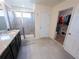 Bathroom featuring a glass shower stall, granite countertops, and a walk-in closet at 16274 Taliesin St, Winter Garden, FL 34787