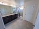 Bathroom with dual sinks, granite countertops, a glass shower, and tiled flooring at 16274 Taliesin St, Winter Garden, FL 34787