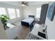 Bedroom features a window, a single bed, a desk, and laminate flooring at 16274 Taliesin St, Winter Garden, FL 34787