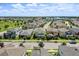 Exterior shot of the neighborhood and a two-story home with beautiful landscaping at 16274 Taliesin St, Winter Garden, FL 34787